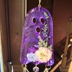 Amethyst holographic purple resin ghost suncatcher has glass beads, acrylic flowers, dried flowers, amethyst chips and real amethyst stone